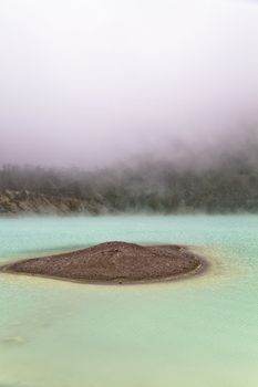 Fog forming over the sand isand in volcanic crater lake surface in Bandung, West Jawa