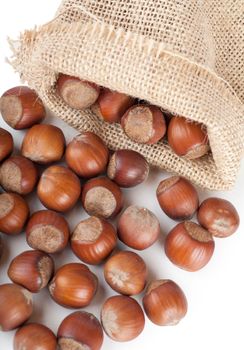 Closeup view of hazelnuts over white background