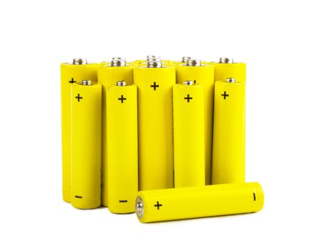 Bunch of yellow batteries isolated over white background