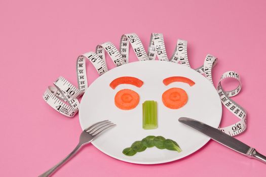 Sad Extreme Diet Salad Face on White Plate Pink Background