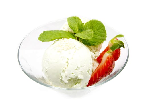 Ice cream with strawberries in a glass beaker decorated with mint