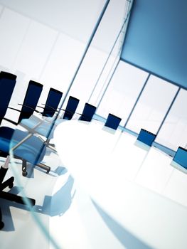 Empty meeting room with rounded table and light from windows