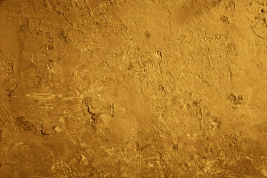 old brown wall with visible cracks and hollows