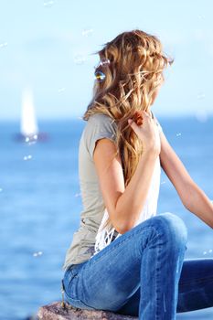 happy blond hair woman sea on background