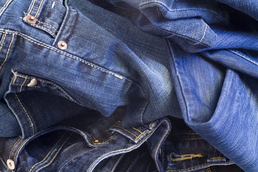 folded new blue jeans as fashion background
