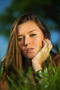 happy woman lay on green grass under tree