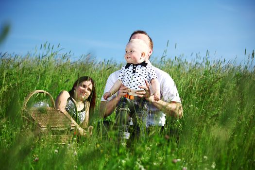  happy family on picnic in green grass