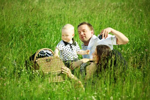  happy family on picnic in green grass