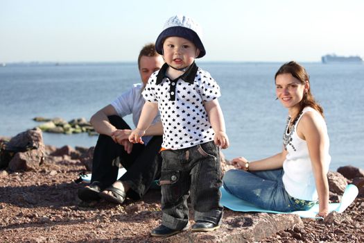 happy family on picnic sea on background