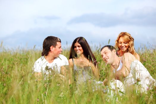 friends and dog in green grass field