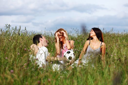 friends and dog in green grass field