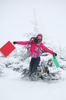 winter girl jump with gift on snow background