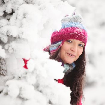 winter girl behind snow tree 