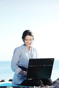 woman with laptop sea background