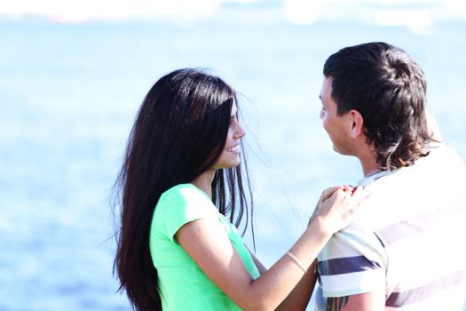 man and woman hug in the sky sea on background