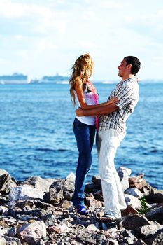 man and woman hug in the sky and sea on sea