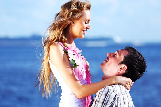 man and woman hug in the sky and sea on sea