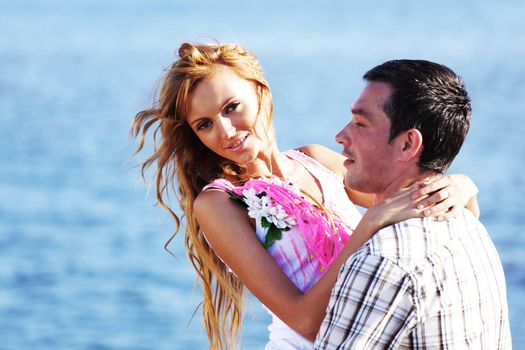 man and woman hug in the sky and sea on sea