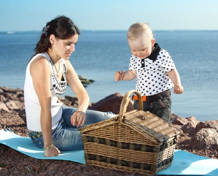 happy mother and son on picnic near sea