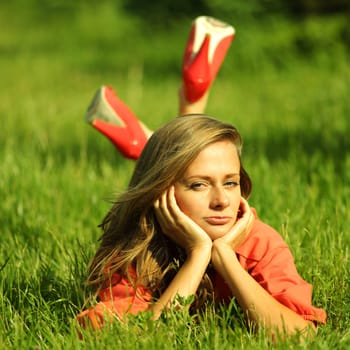 young sommer woman on green grass