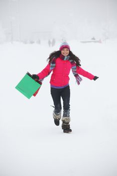 winter girl with gift bags on snow background