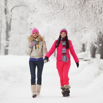 two winter women run by snow frosted alley