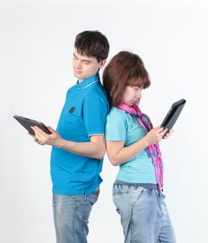 A young couple with a Tablet PC, on gray background