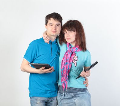 A young couple with a Tablet PC, on gray background