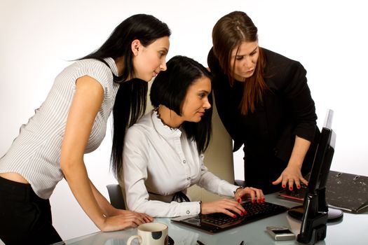 Three  office women working together on a computer
