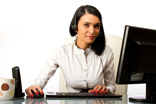 Office worker, secretary at her desk working on a computer