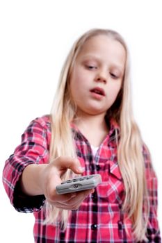 a little girl holds the TV remote control