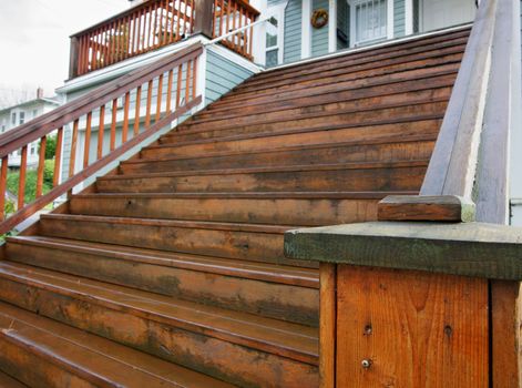 Many steps in a wood staircase to a home