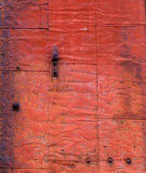 Red brown and orange rusted and weathered steel sliding door