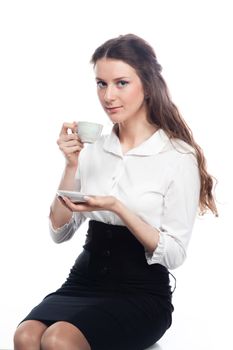 Young, beautiful and successful business woman drinking coffee from a white cup