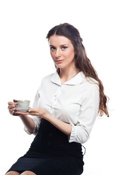 Young, beautiful and successful business woman drinking coffee from a white cup