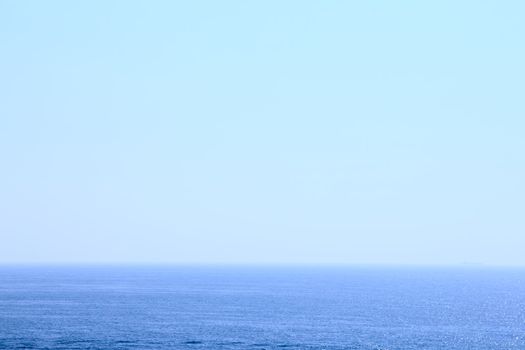 Blue sea under transparent clear sky