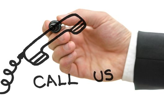 Businessman hand writing a call us message with a drawing of phone on a glass board. Over white background.