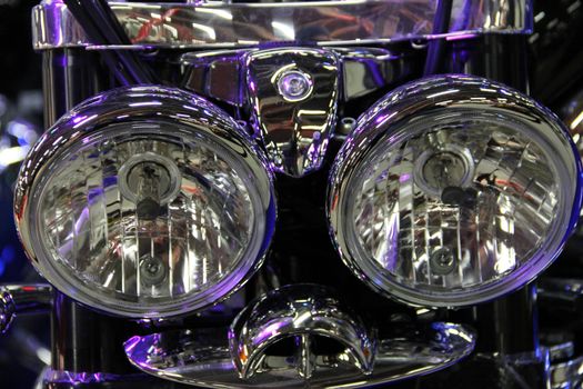 Shiny motorcycle headlight macro close up