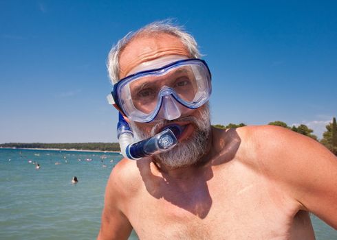 A man with a mask and snorkel for swimming