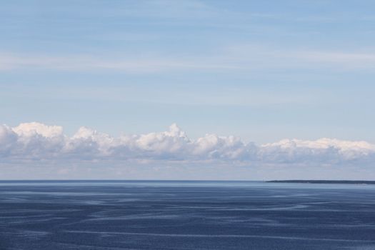 Blue ocean and bright sky with beautiful clouds