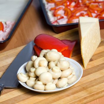 Stock photo: an image of  mushrooms, paprika, cheese and knife on the table