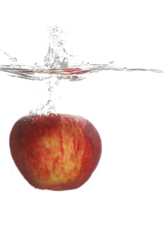 Red apple falling in water