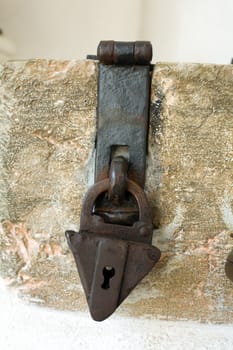 An image of antique padlock on neutral background