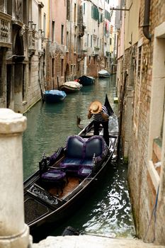 An image of a gondola  in a narrow canal