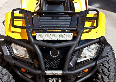 a yellow quad bike - front view