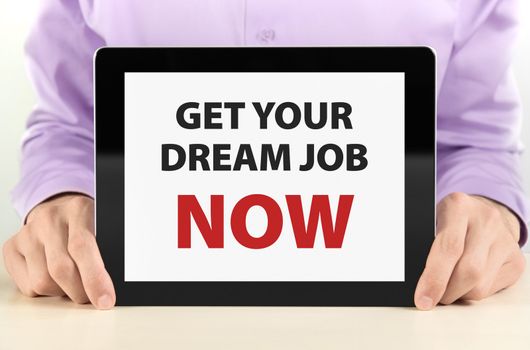 Manager holding tablet pc with "Get Your Dream Job Now" text on screen.