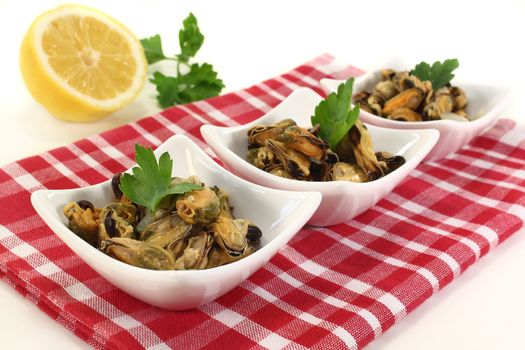 a bowl of marinated mussels and parsley