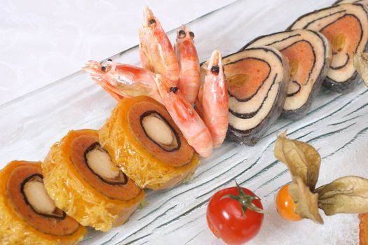 Stuffed fish and prawns with vegetables on plate