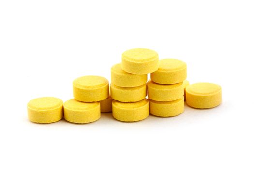 Yelow pills isolated on white