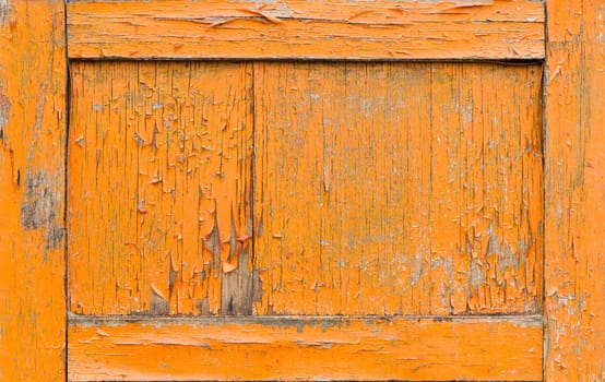 Cracked orange paint on old door